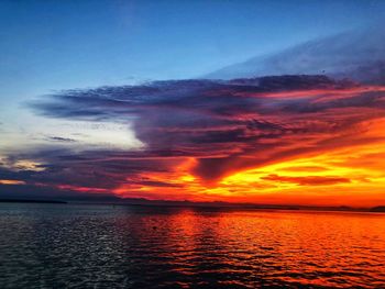 Scenic view of sea against romantic sky at sunset