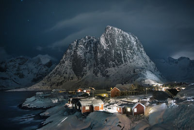 Aerial view of snowcapped mountains against sky at night