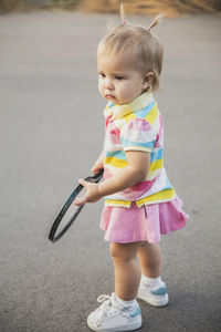 Portrait of cute boy standing on road