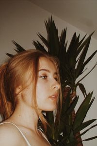 Portrait of young woman with plants
