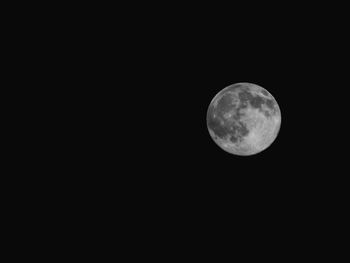 Low angle view of moon against clear sky at night