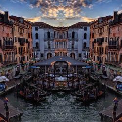 Boats in canal against buildings in city