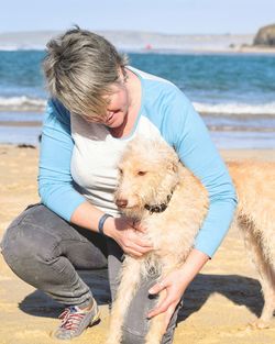 Woman with dog on beach