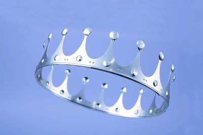 Low angle view of crown against purple background