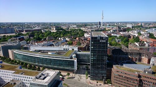 High angle view of city buildings against clear sky