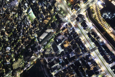 Aerial view of illuminated city buildings at night