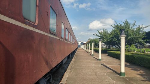 Train amidst trees against sky