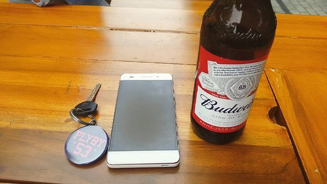 indoors, table, text, communication, high angle view, still life, wood - material, western script, drink, close-up, refreshment, food and drink, no people, technology, wooden, flooring, hardwood floor, day, coffee cup, home interior