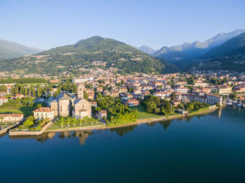 Aerial view of townscape by mountain against sky