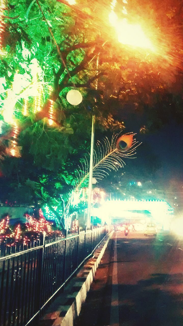 VIEW OF ILLUMINATED STREET AT NIGHT