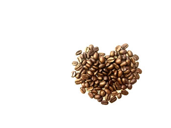 High angle view of coffee beans against white background