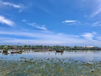 Scenic view of sea by buildings against sky