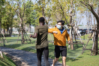 Full length of men walking in park