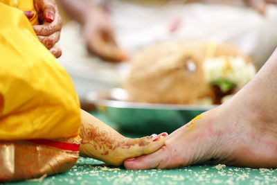 Low section of bride and bridegroom during wedding ceremony