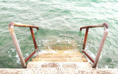 High angle view of ladder by swimming pool