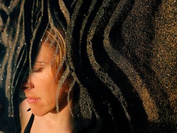 Close-up portrait of woman with reflection in water