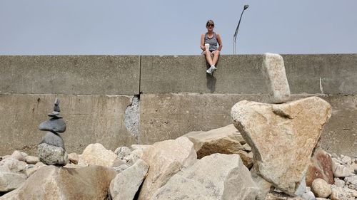 Full length of woman on rock against sky