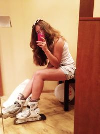 Young woman sitting at home