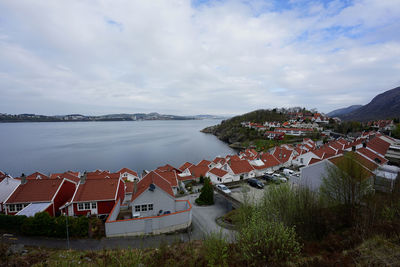 High angle view of townscape by river against sky