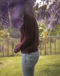 Woman standing on purple tree