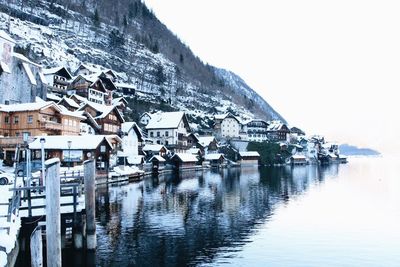 Houses at waterfront against sky