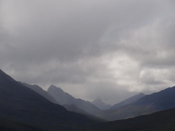 Scenic view of mountains against cloudy sky