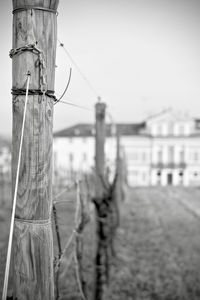 Close-up of barbed wire fence against sky