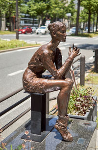 Statue on footpath in park