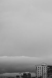 Buildings by sea against sky