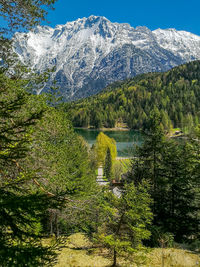 Scenic view of lake by mountains against sky