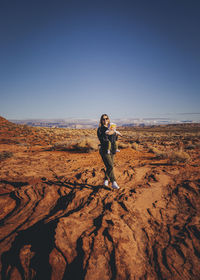 Full length of man standing on land against sky