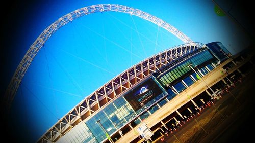 Low angle view of modern building against blue sky