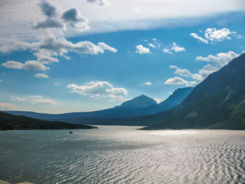 Scenic view of sea and mountains against sky