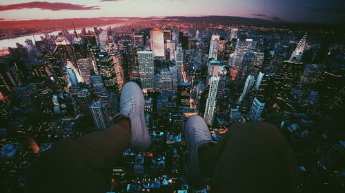 High angle view of man with hand against sky at night