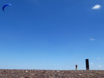 Man flying kites against sky