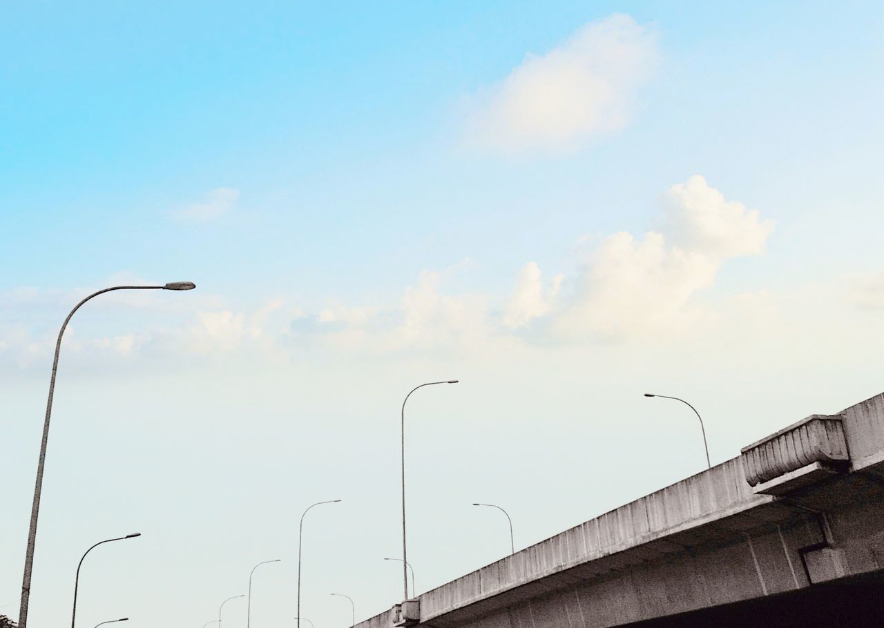 sky, street light, street, cloud - sky, lighting equipment, built structure, architecture, nature, low angle view, no people, day, outdoors, transportation, city, bird, building exterior, direction, light, in a row, flying, place