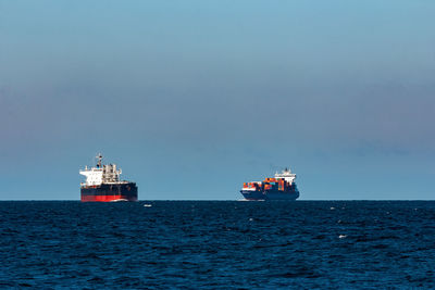 Ship sailing on sea against sky