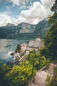 Church at lakeshore against mountains