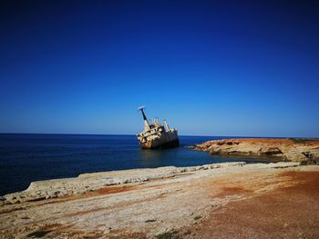 Scenic view of sea against clear blue sky