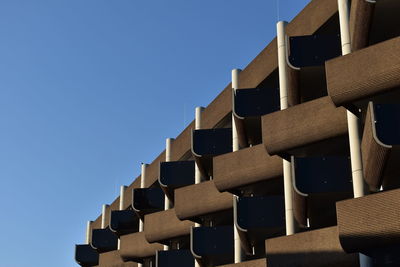 Low angle view of stack against blue sky