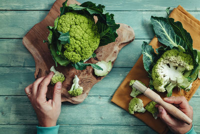 High angle view of person holding food on table