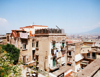 Buildings in city against clear sky