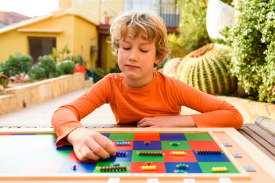 Boy playing checkerboard