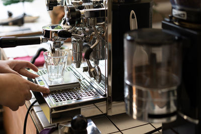 Barista making espresso with coffee machine.