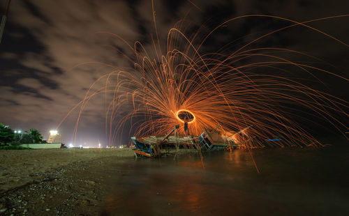 Firework display over river at night