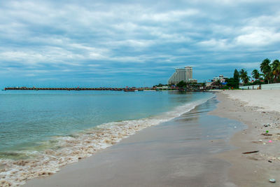 Scenic view of beach against sky in city