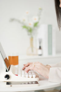 Asian business and writer woman meeting online and typing by use retro keyboard and tablet