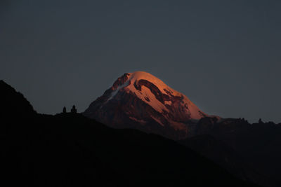 Scenic view of snowcapped mountains against clear sky