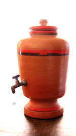 Close-up of fire hydrant on table against white background