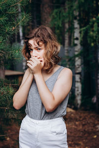 Teenager girl holds her head with hands. psychological problem and mental health during puberty